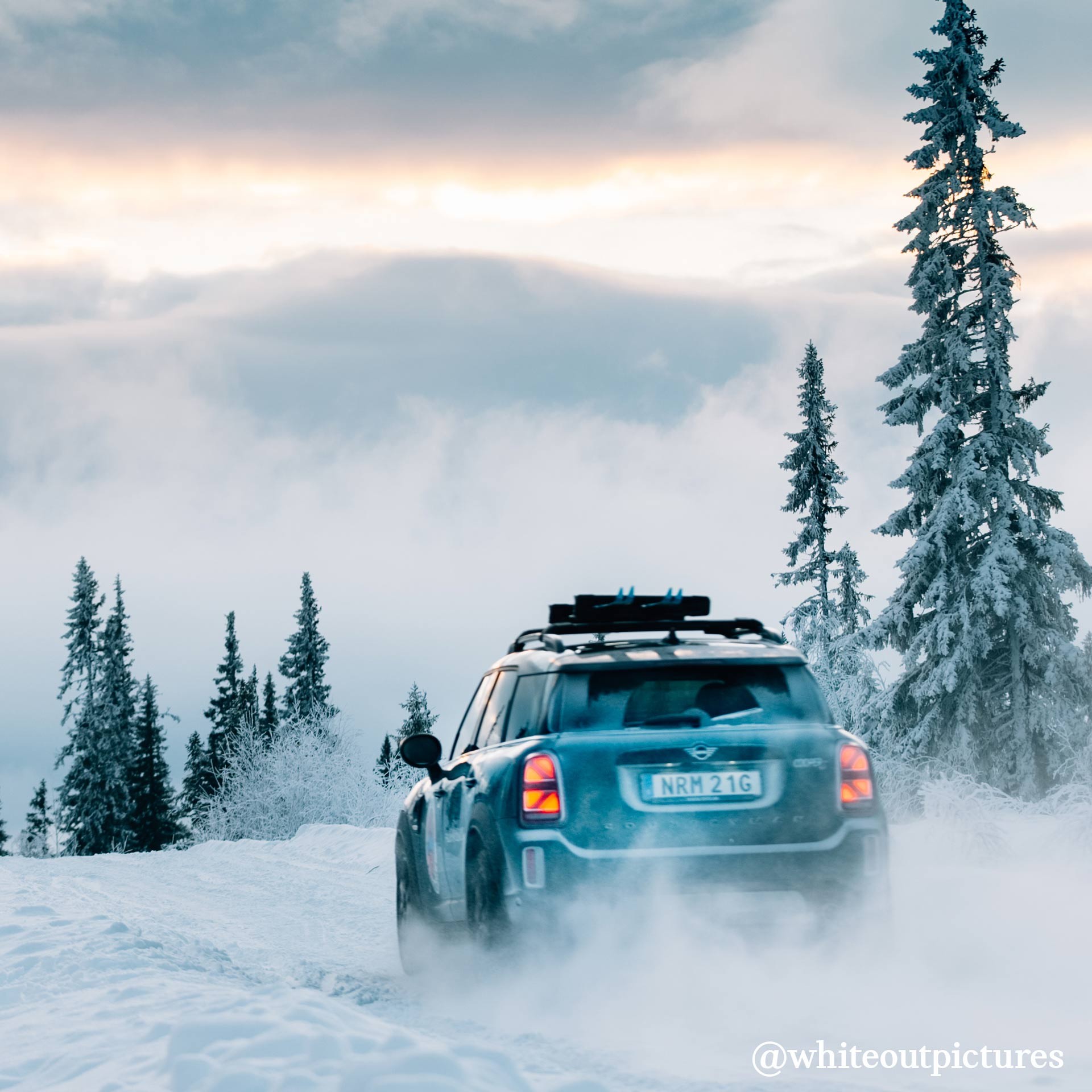 MINI COOPER COUNTRYMAN outdoors in the snow rear view